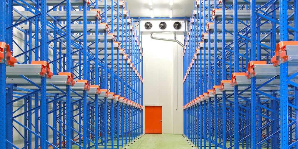 refrigerated and freezing warehouse with blue shelves and an orange door