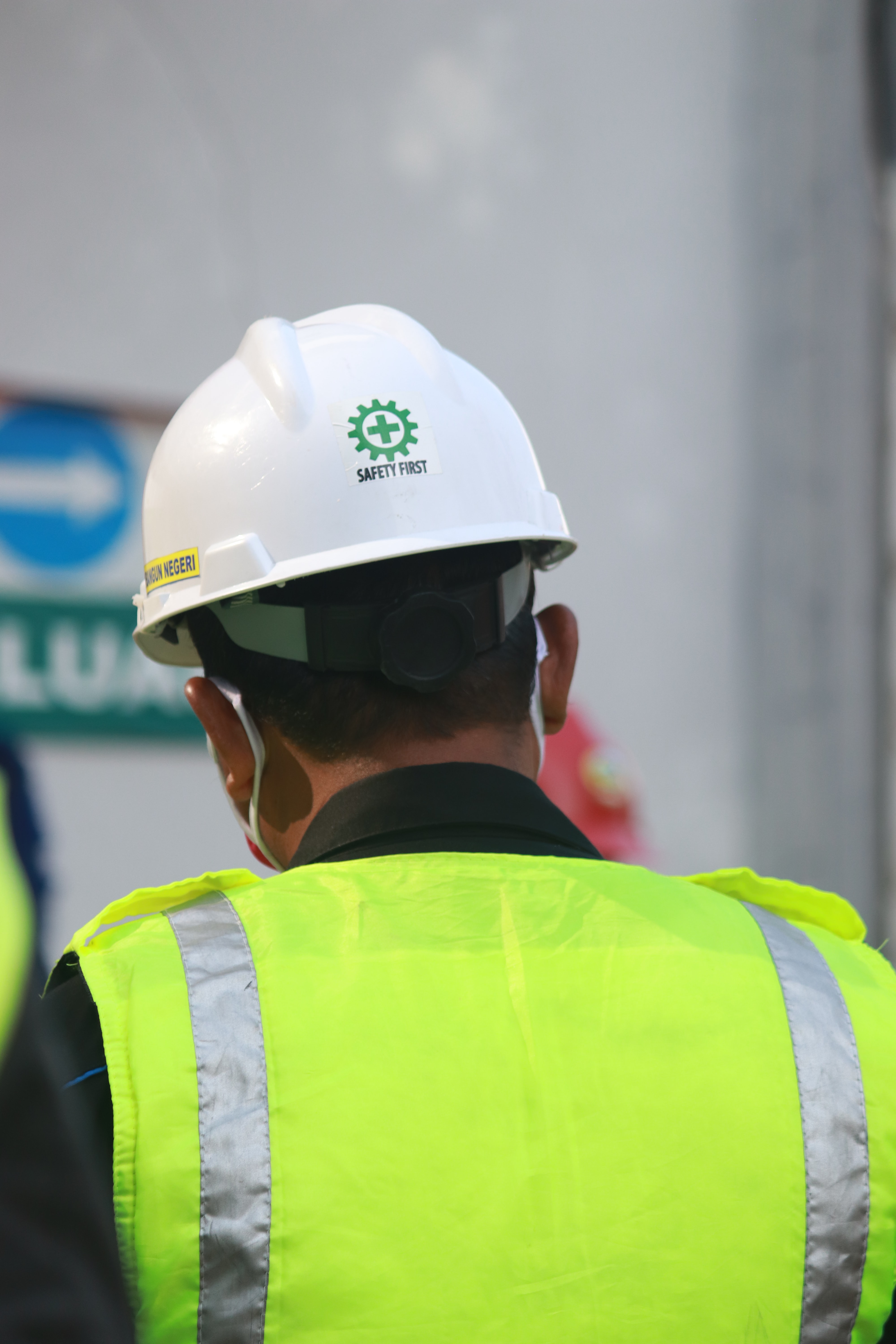 Green Span Profiles Why Your Commercial Project Should Exceed Building Code Construction Worker in Vest and Helmet