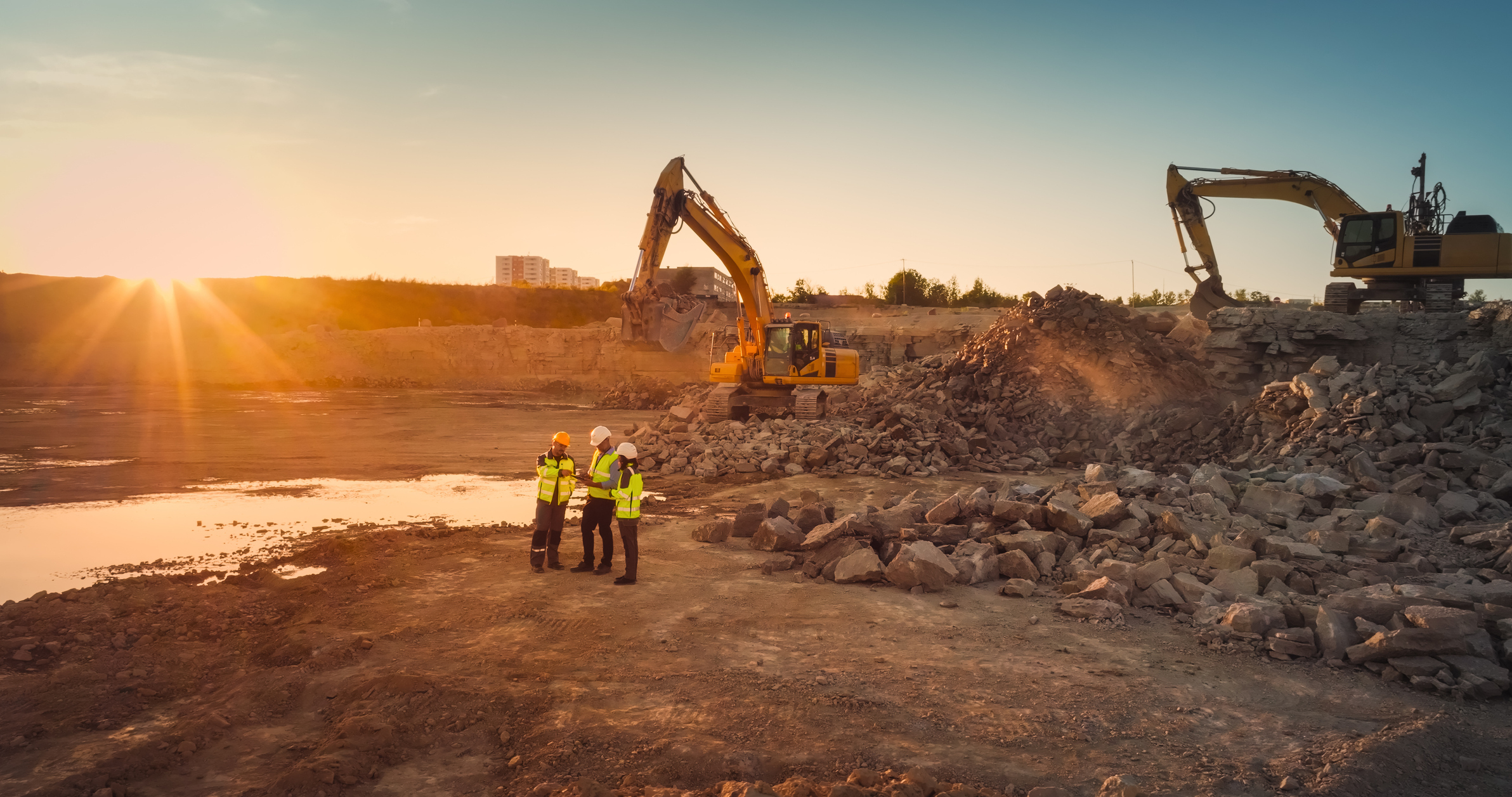 Aerial shot of construction site with excavators on sunny day