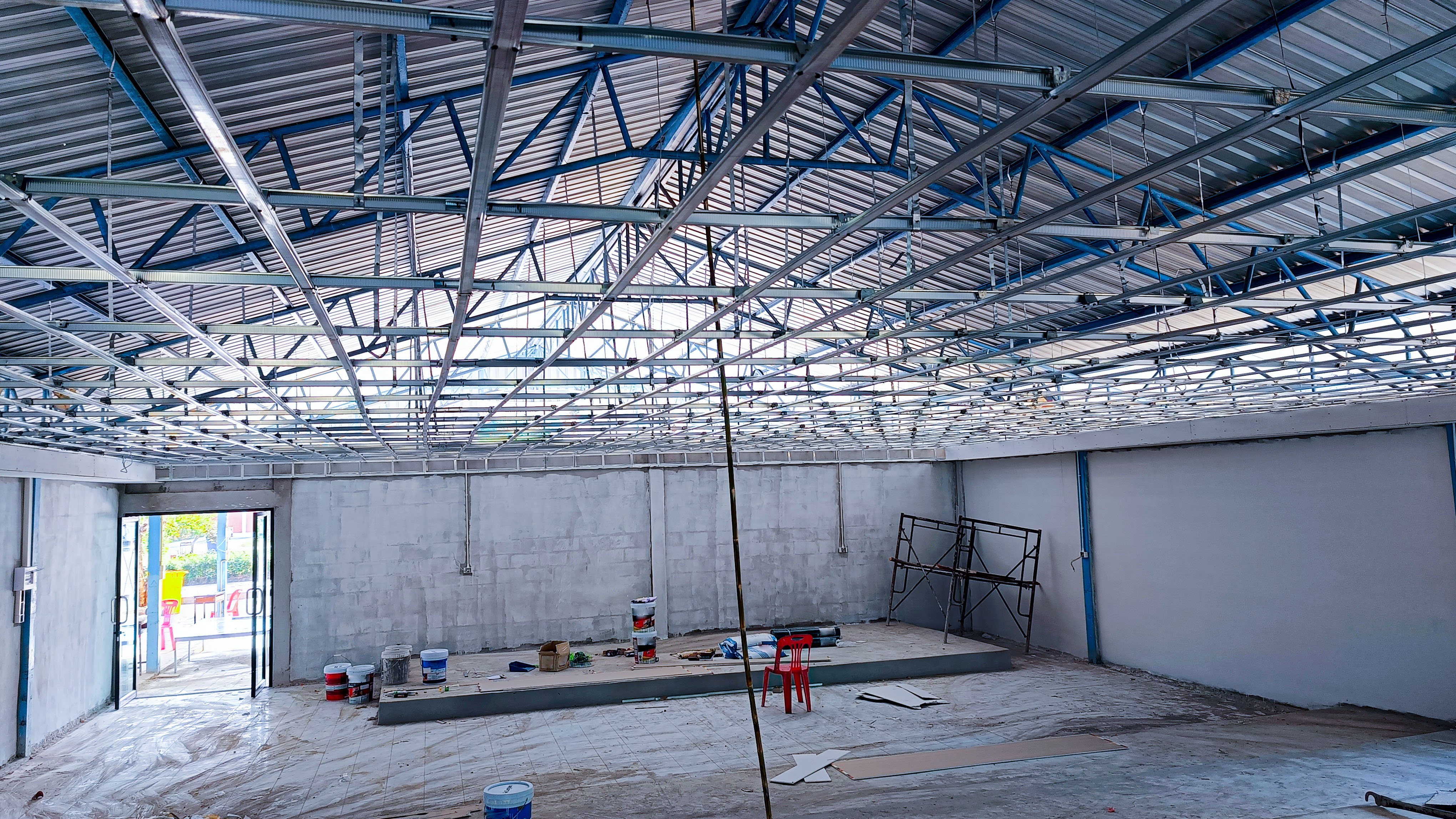 Metal ceiling installation in warehouse during the construction process